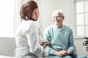 A doctor and a patient sitting on a white couch