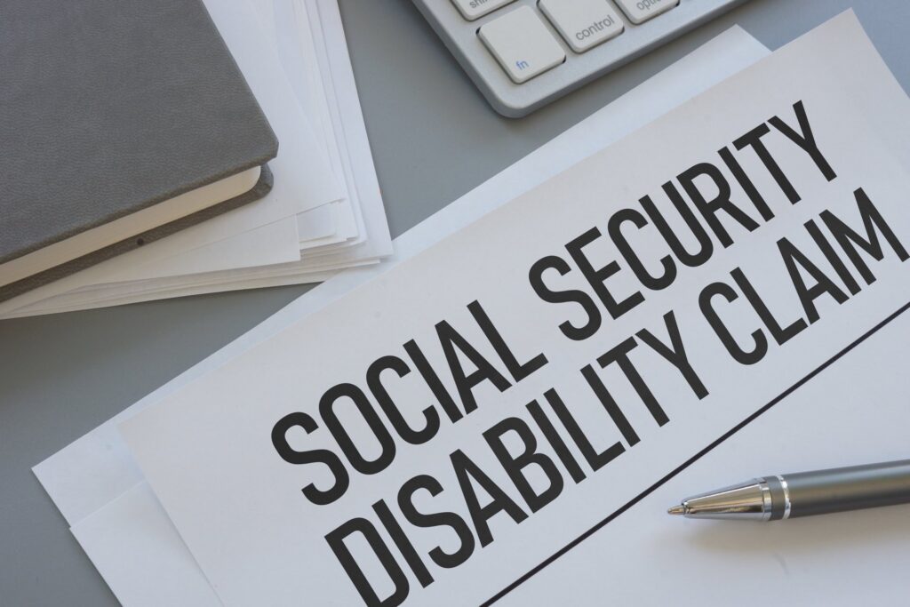 A pen on top of paper that says social security diability claim