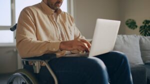 Person in wheel chair on a laptop