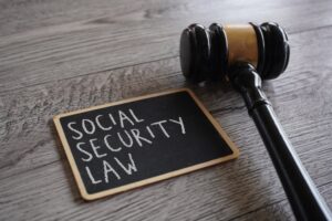 Chalkboard that says social security law next to a gavel