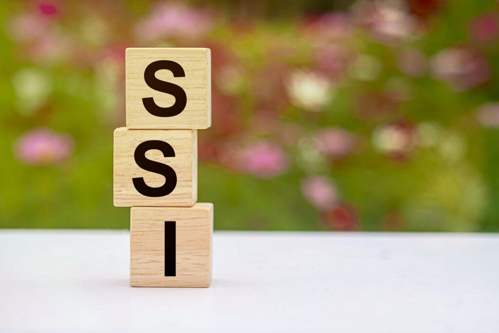 SSI on wooden blocks with flower background blurred