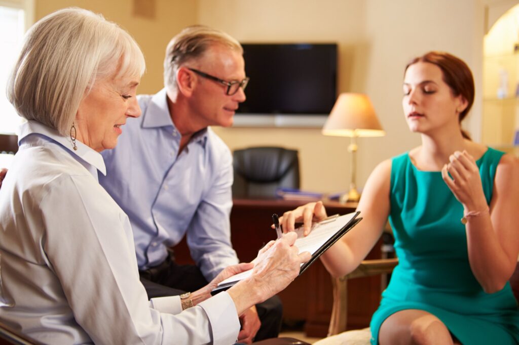 Lawyer going over paperwork with older clients