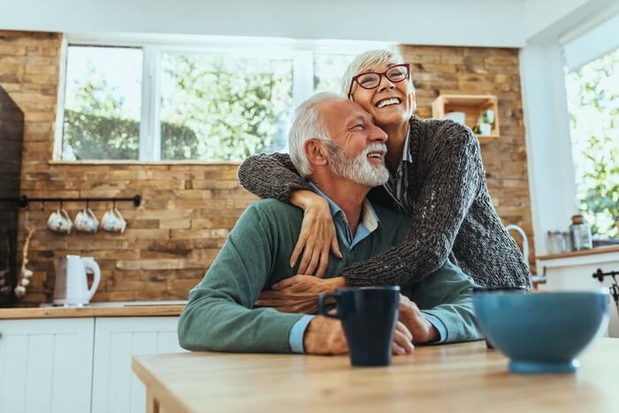 An elderly couple at a kitchen table | Schott Law